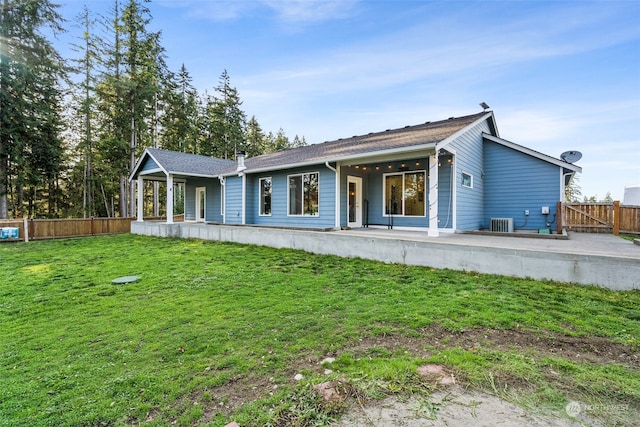 ranch-style house featuring a front lawn and central air condition unit