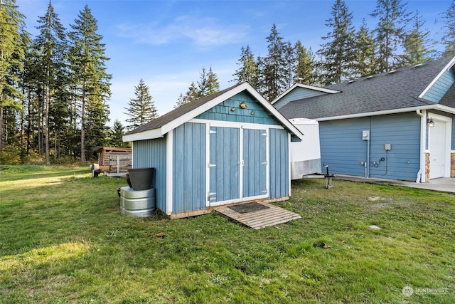 view of outdoor structure with a lawn