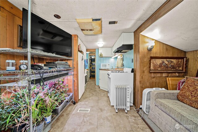 137 Mountain View Dr N, Ashford, WA 98304 - interior space featuring radiator, wooden walls, and visible vents