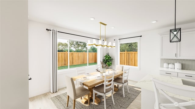 dining space with light hardwood / wood-style flooring and a healthy amount of sunlight