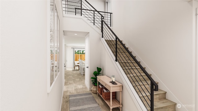 stairs featuring hardwood / wood-style floors