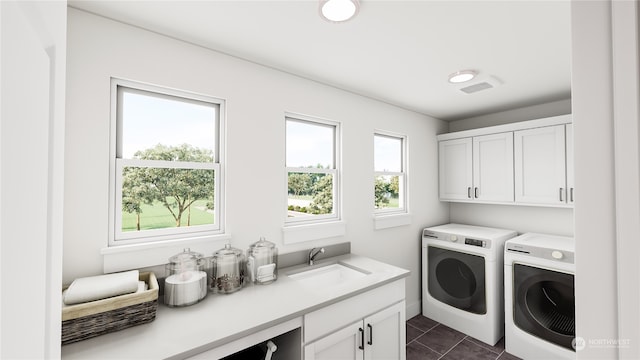 laundry room featuring cabinets, a healthy amount of sunlight, sink, and separate washer and dryer