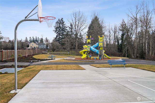 view of sport court with a playground and a yard