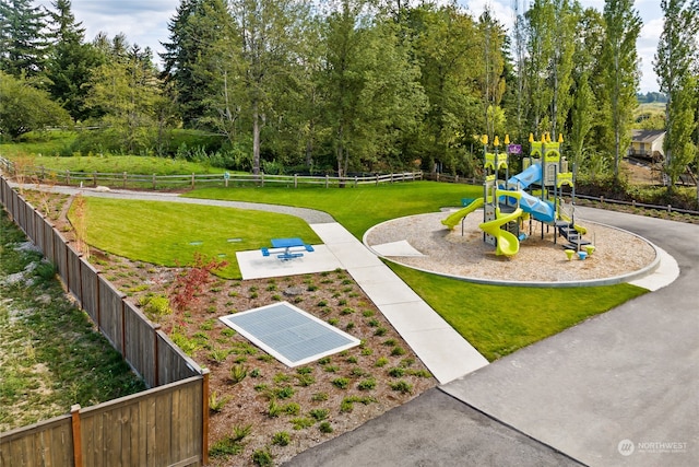 view of community with a lawn and a playground