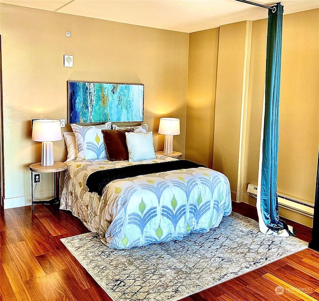 bedroom with hardwood / wood-style floors