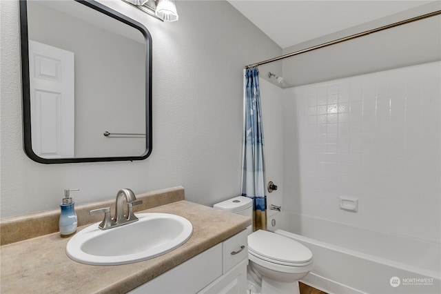 full bathroom with vanity, shower / tub combo, and toilet