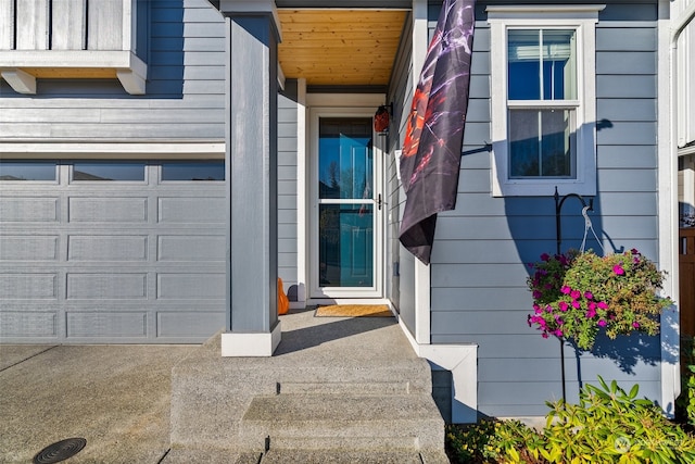 view of exterior entry featuring a garage