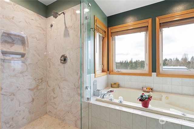 bathroom featuring independent shower and bath