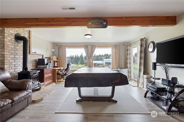 rec room featuring light hardwood / wood-style floors and beam ceiling