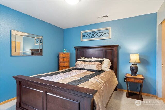 bedroom featuring light colored carpet