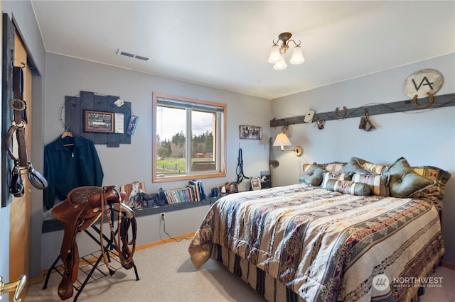 carpeted bedroom with an inviting chandelier