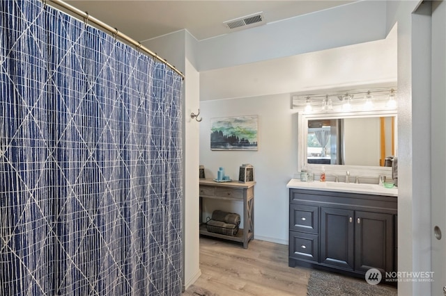 bathroom with vanity, a shower with shower curtain, and wood-type flooring