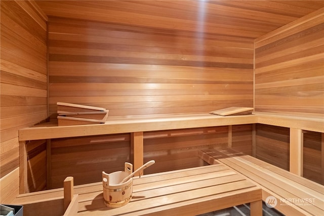 view of sauna / steam room featuring wood ceiling and wood walls