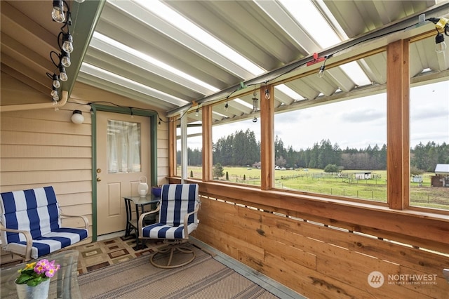 unfurnished sunroom with lofted ceiling and a healthy amount of sunlight