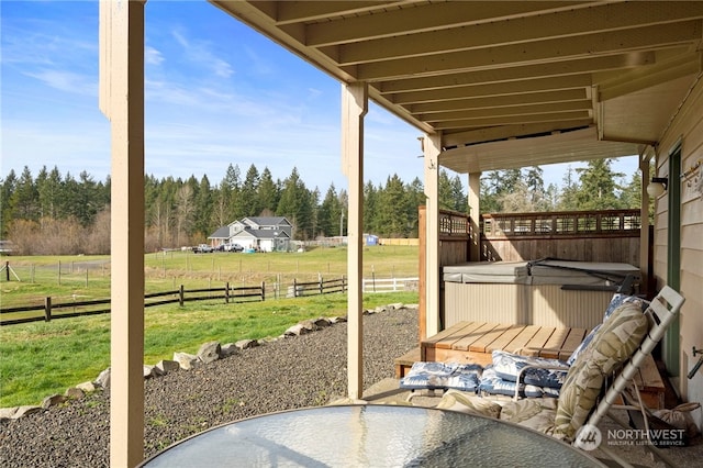 view of patio featuring a rural view and a hot tub