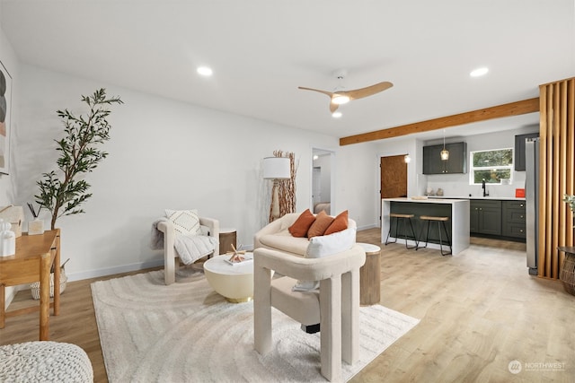 living room featuring light hardwood / wood-style floors and ceiling fan