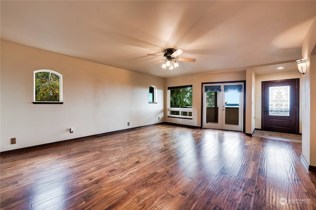 unfurnished living room with hardwood / wood-style flooring, a healthy amount of sunlight, and ceiling fan