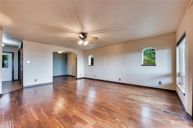 empty room featuring ceiling fan and hardwood / wood-style floors