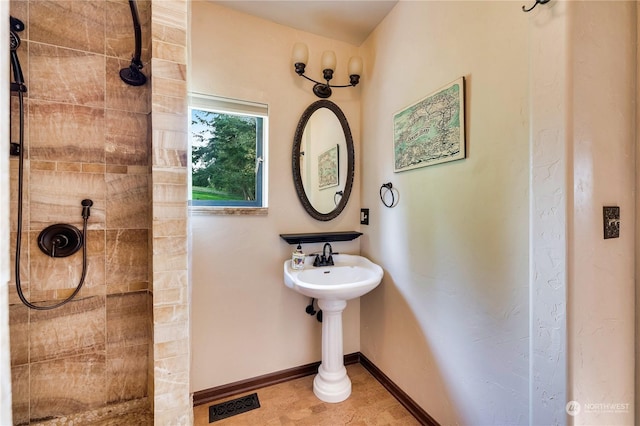 212 Grandview Ave, Camano Island, WA 98282 - bathroom featuring baseboards, visible vents, and a tile shower