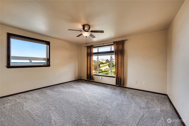 empty room featuring carpet floors and ceiling fan