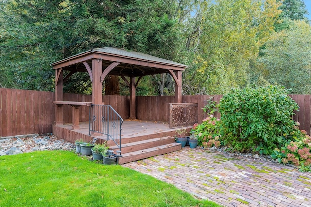 wooden deck with a gazebo, a yard, and a patio