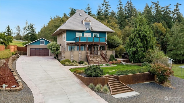 212 Grandview Ave, Camano Island, WA 98282 - view of front facade with a balcony, fence, an outdoor structure, a detached garage, and stairway