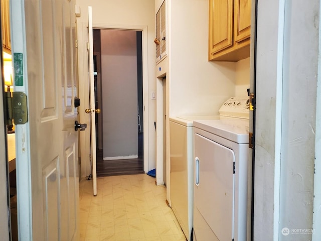 laundry room featuring independent washer and dryer and cabinets