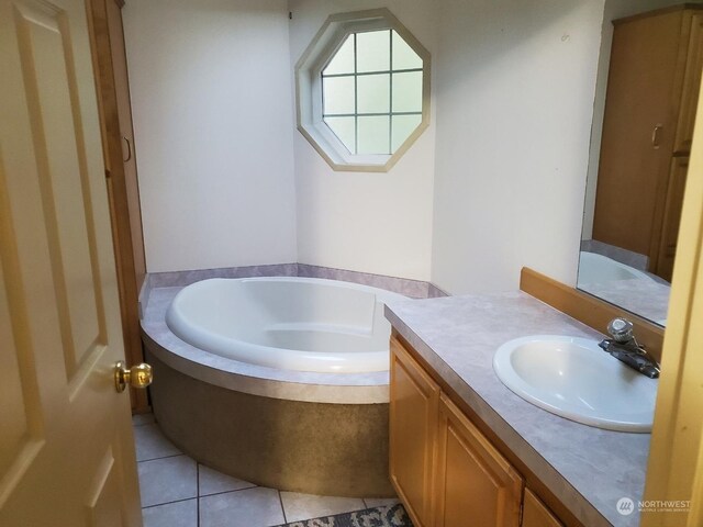 bathroom with vanity, tile patterned floors, and a washtub