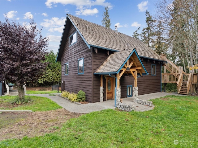 view of front of property with a wooden deck and a front yard