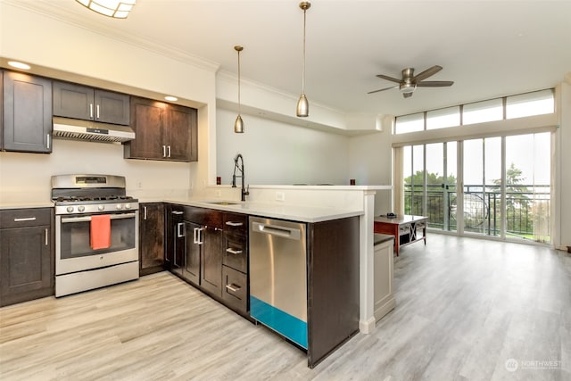 kitchen with crown molding, appliances with stainless steel finishes, kitchen peninsula, and hanging light fixtures
