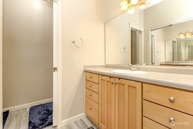 bathroom with vanity and hardwood / wood-style floors