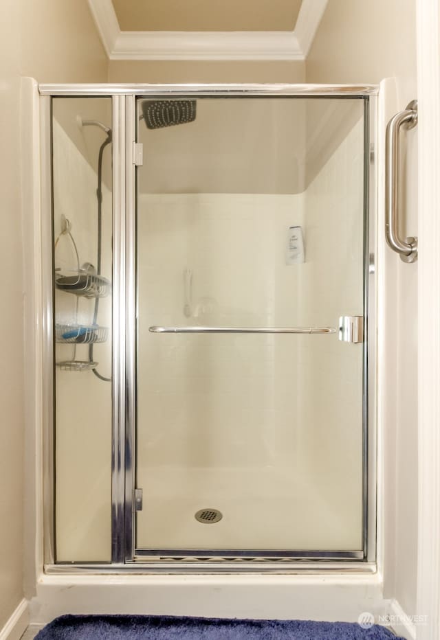 bathroom featuring crown molding and an enclosed shower