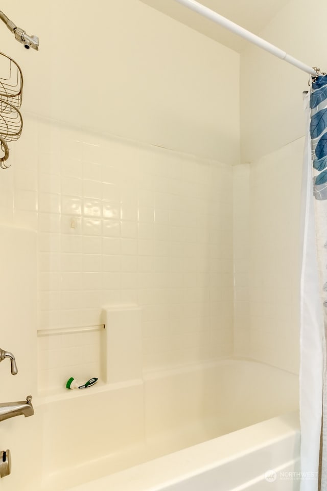 bathroom with shower / bath combination with curtain