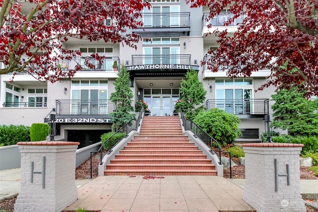 view of front of home with a balcony and a garage