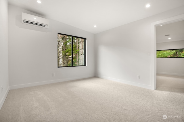 carpeted empty room with a wall mounted AC