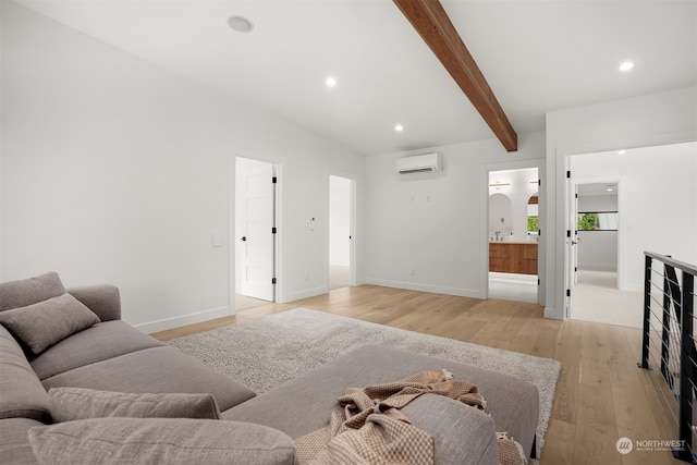 living room featuring light hardwood / wood-style floors, an AC wall unit, and beam ceiling