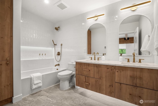 full bathroom featuring vanity, toilet, tile walls, and tub / shower combination