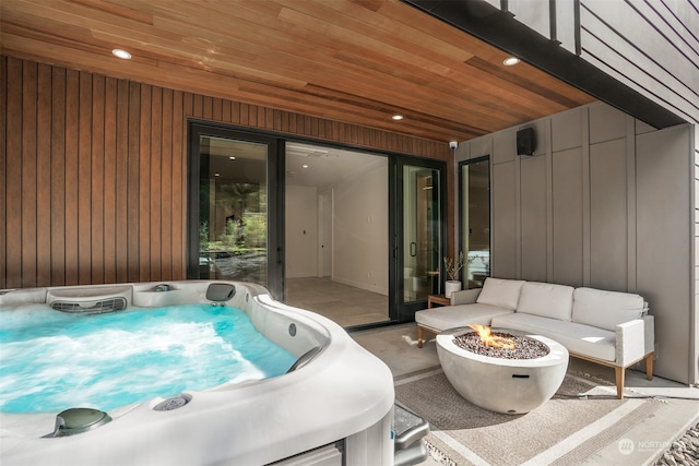 view of patio featuring a hot tub and an outdoor fire pit