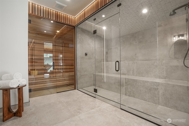 bathroom with concrete floors and an enclosed shower