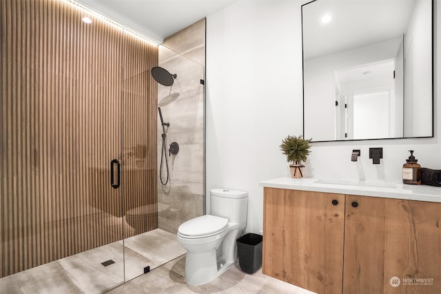 bathroom with vanity, toilet, a shower with shower door, and tile patterned flooring