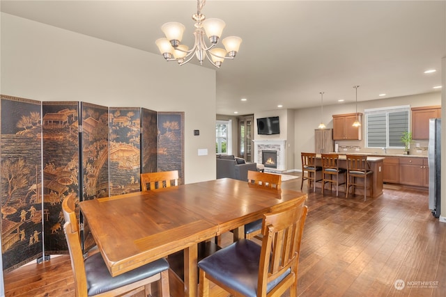 dining area featuring a notable chandelier and dark wood-type flooring