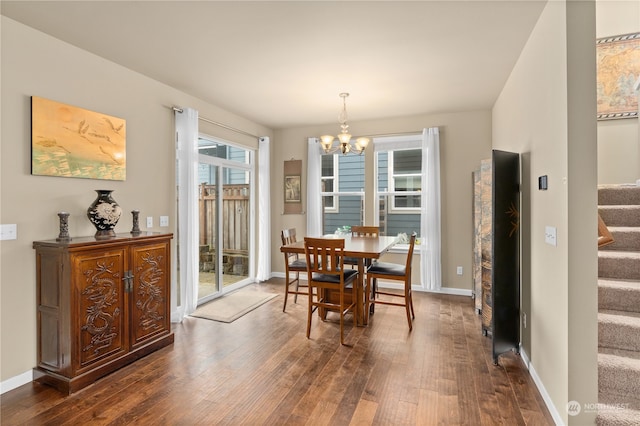 dining room featuring dark hardwood / wood-style floors and an inviting chandelier