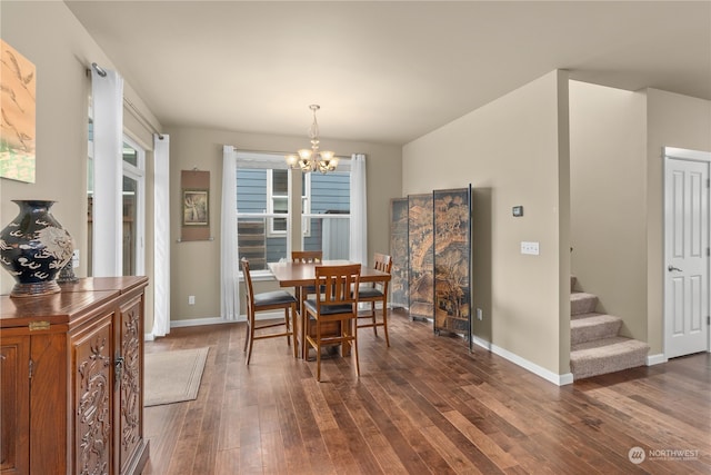 dining room featuring dark hardwood / wood-style flooring and an inviting chandelier