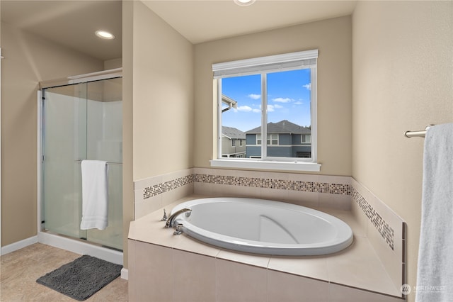 bathroom featuring shower with separate bathtub