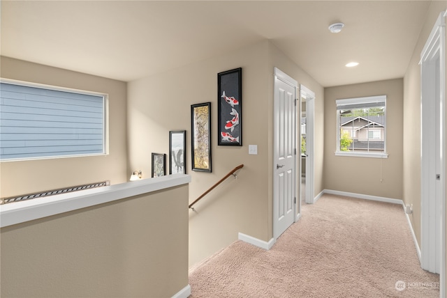 corridor featuring light colored carpet