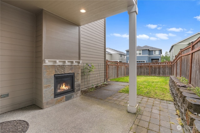 view of patio with a fireplace