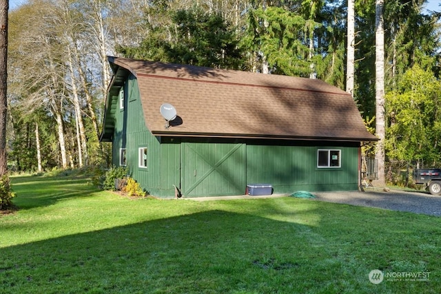 view of outbuilding featuring a lawn