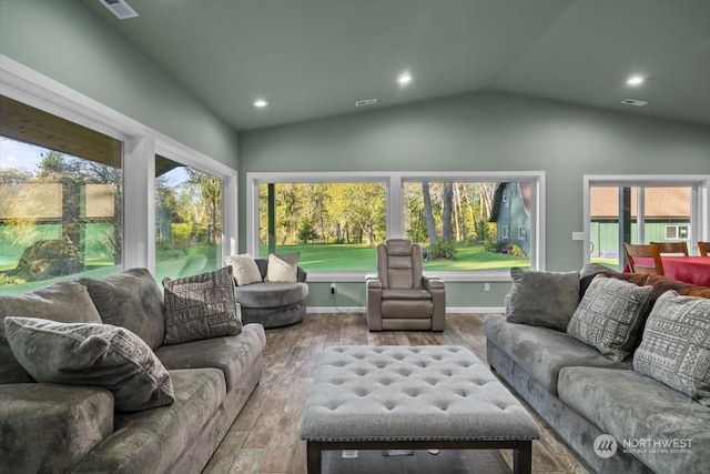 living room featuring lofted ceiling, plenty of natural light, and hardwood / wood-style floors