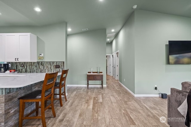 dining space with lofted ceiling and light hardwood / wood-style floors