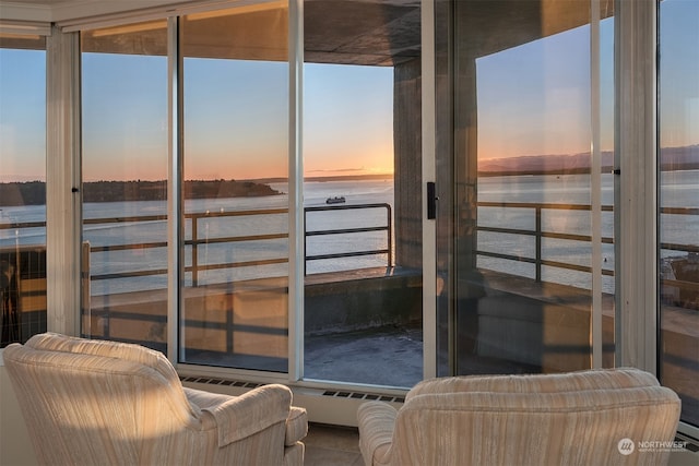 sunroom / solarium featuring a water view